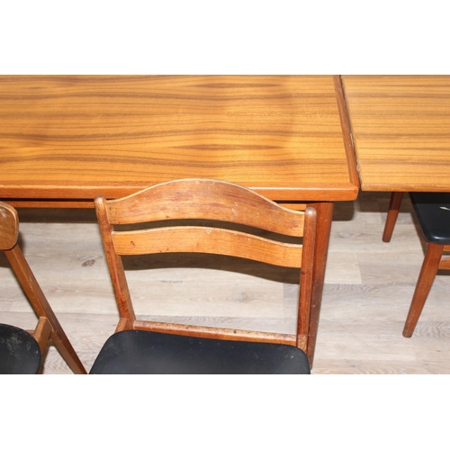 151 - A retro extending dining table and a set of 4 harlequin matched retro dining chairs, all pieces seem... 