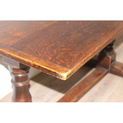 141 - An antique style oak refectory table on turned legs, approx 150cm x 83cm x 75cm