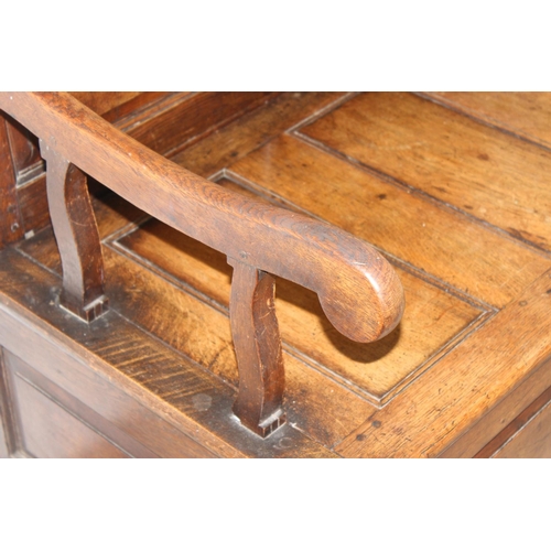 140 - An antique oak monk's bench or settle on castors, pegged joints with lift up seat, approx 115cm x 59... 