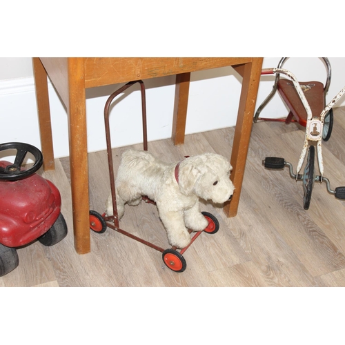 695 - Vintage pine children's school desk, with a push-along dog stuffed dog, tin-plate tricycle and ride ... 