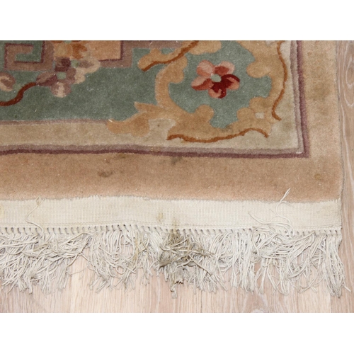 209 - A deep pile beige ground wool rug, likely Chinese, approx 200cm  x 126cm