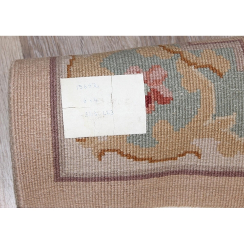 209 - A deep pile beige ground wool rug, likely Chinese, approx 200cm  x 126cm