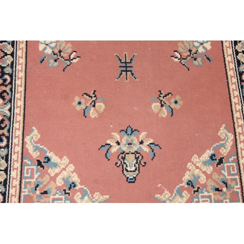 210 - A modern wool runner rug of salmon ground, approx 340cm  x 80cm