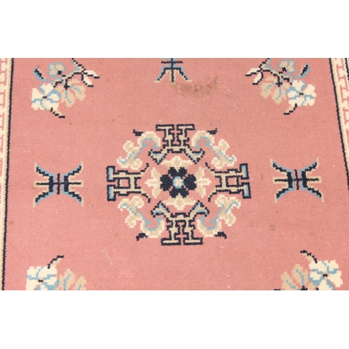 210 - A modern wool runner rug of salmon ground, approx 340cm  x 80cm