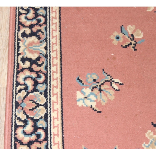 210 - A modern wool runner rug of salmon ground, approx 340cm  x 80cm