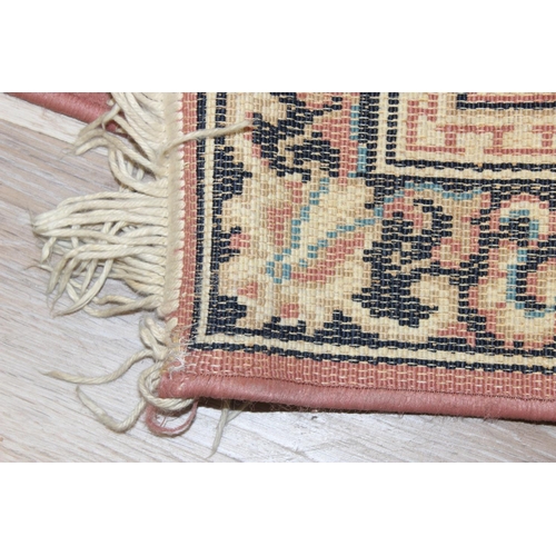 210 - A modern wool runner rug of salmon ground, approx 340cm  x 80cm