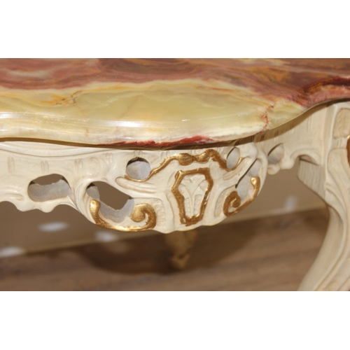 126 - A Baroque style onyx topped low table with painted and gilt wooden base and a highly figured green o... 