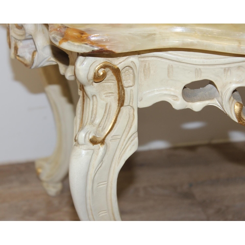 126 - A Baroque style onyx topped low table with painted and gilt wooden base and a highly figured green o... 