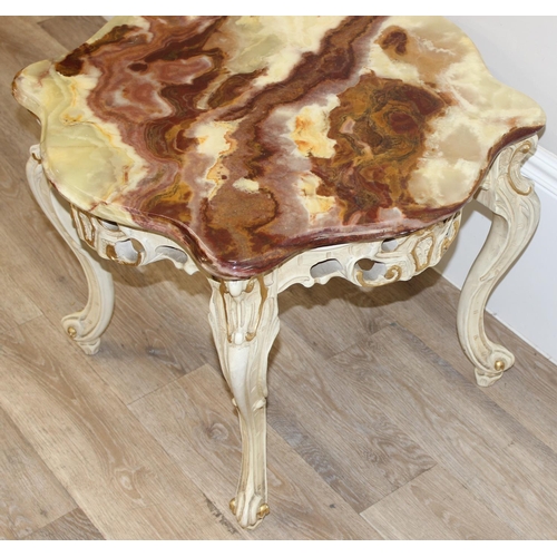 126 - A Baroque style onyx topped low table with painted and gilt wooden base and a highly figured green o... 