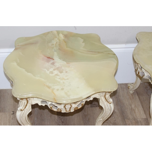 125 - A pair of Baroque style onyx topped low tables with painted and gilt wooden bases and green onyx sha... 