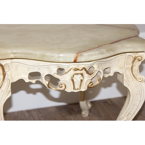 125 - A pair of Baroque style onyx topped low tables with painted and gilt wooden bases and green onyx sha... 