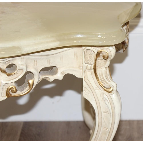 125 - A pair of Baroque style onyx topped low tables with painted and gilt wooden bases and green onyx sha... 