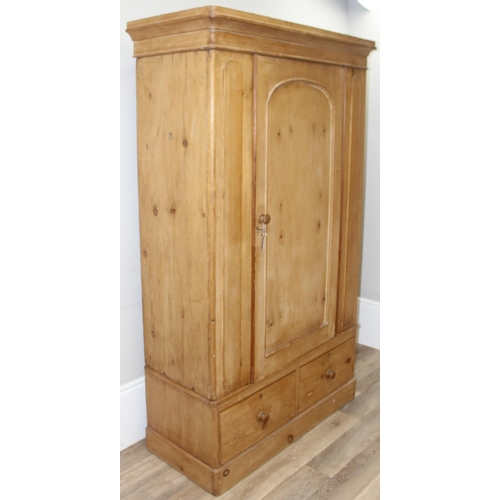 109 - A Victorian pine wardrobe with 2 drawer base, the top with both rail and pegs to interior, 2 origina... 