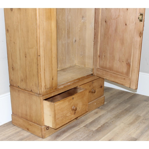 109 - A Victorian pine wardrobe with 2 drawer base, the top with both rail and pegs to interior, 2 origina... 