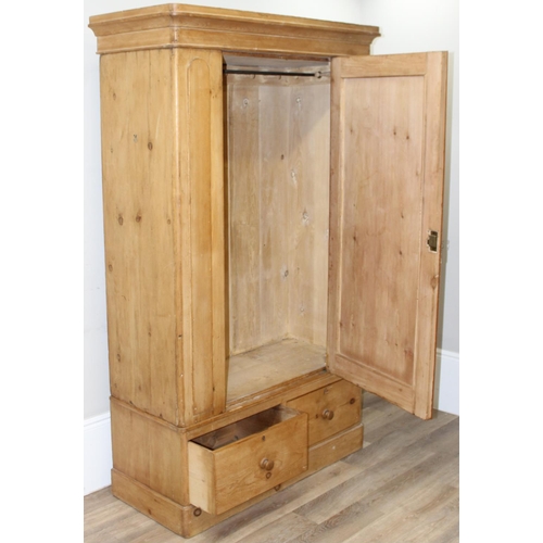 109 - A Victorian pine wardrobe with 2 drawer base, the top with both rail and pegs to interior, 2 origina... 