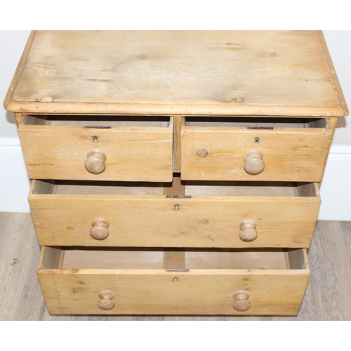 110 - A Victorian pine 2 over 2 chest of drawers with turned wooden feet and bun handles, approx 84cm wide... 