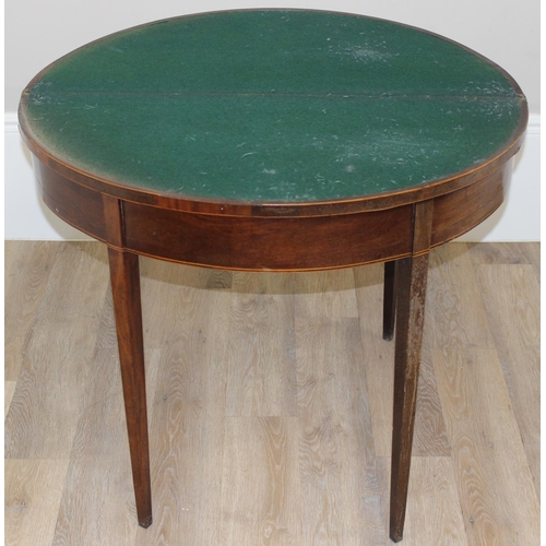 93 - A Victorian mahogany demi-lune card table with fold over top and green baize lined interior, approx ... 