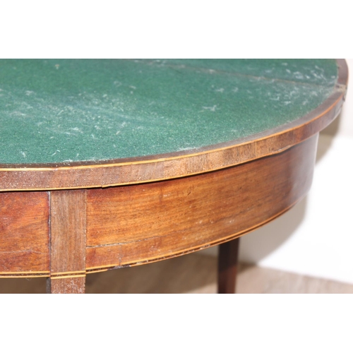 93 - A Victorian mahogany demi-lune card table with fold over top and green baize lined interior, approx ... 