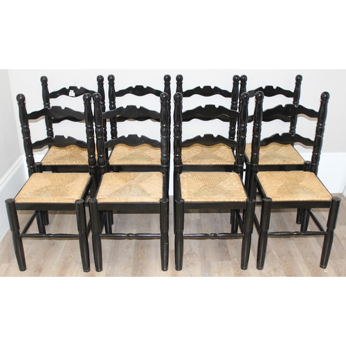 116 - A set of 8 Arts & Crafts style black painted chairs with rush seats, each approx 96cm tall