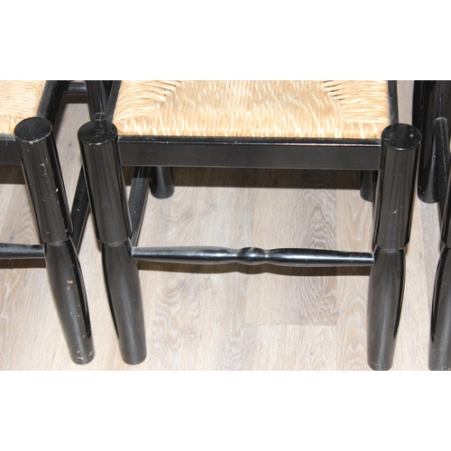 116 - A set of 8 Arts & Crafts style black painted chairs with rush seats, each approx 96cm tall