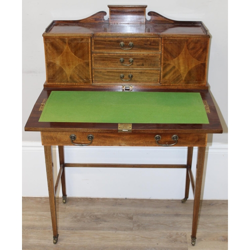 80 - An Edwardian ladies writing desk with various small cupboards and drawers over a green baize lined f... 