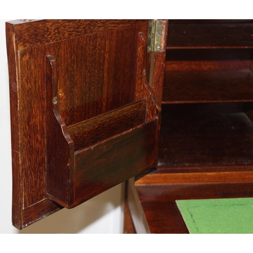 80 - An Edwardian ladies writing desk with various small cupboards and drawers over a green baize lined f... 