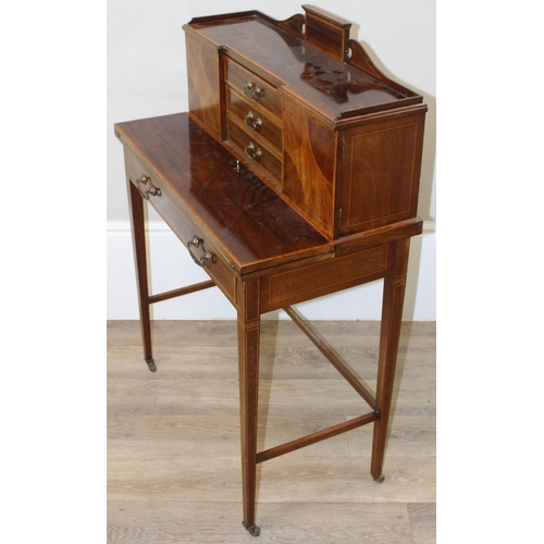 80 - An Edwardian ladies writing desk with various small cupboards and drawers over a green baize lined f... 