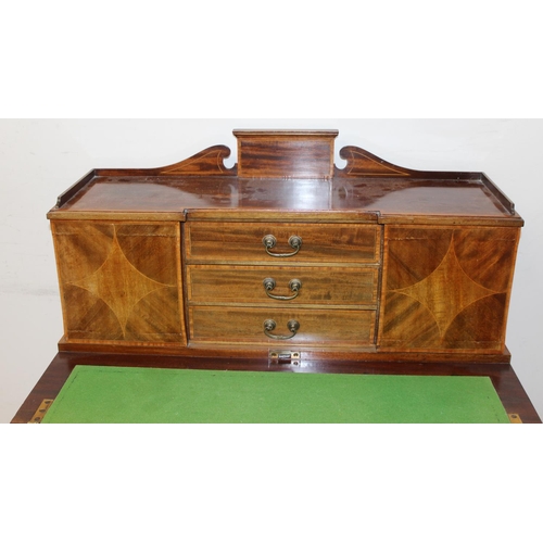 80 - An Edwardian ladies writing desk with various small cupboards and drawers over a green baize lined f... 