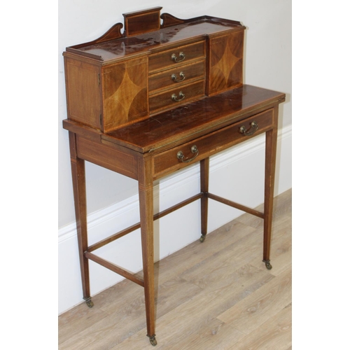 80 - An Edwardian ladies writing desk with various small cupboards and drawers over a green baize lined f... 