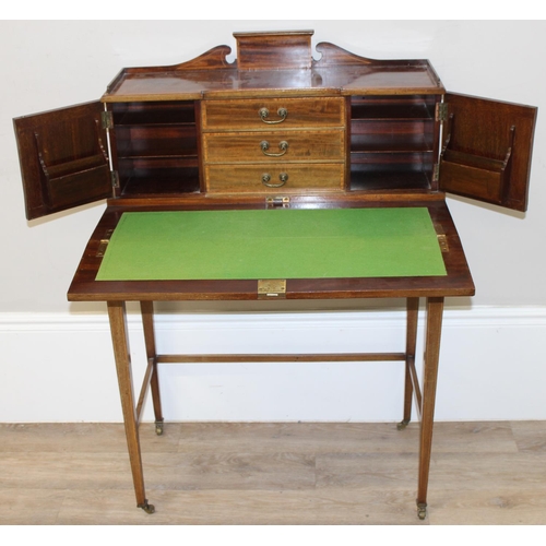 80 - An Edwardian ladies writing desk with various small cupboards and drawers over a green baize lined f... 