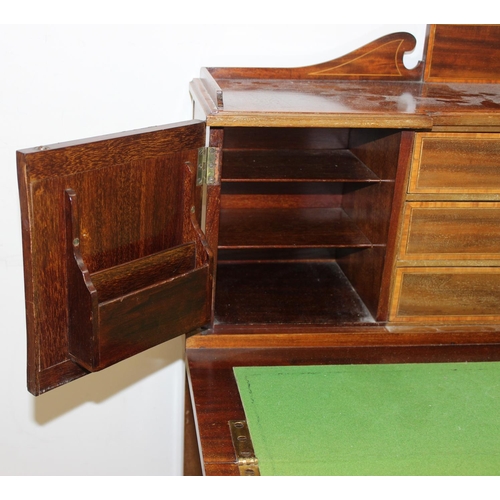 80 - An Edwardian ladies writing desk with various small cupboards and drawers over a green baize lined f... 