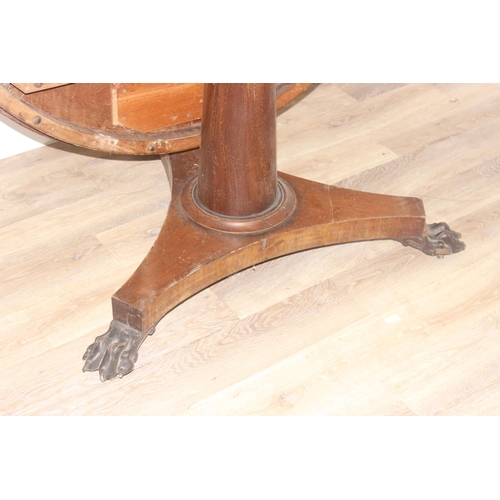 44 - A Victorian mahogany tilt topped breakfast table with pillar support and carved lion paw feet, appro... 