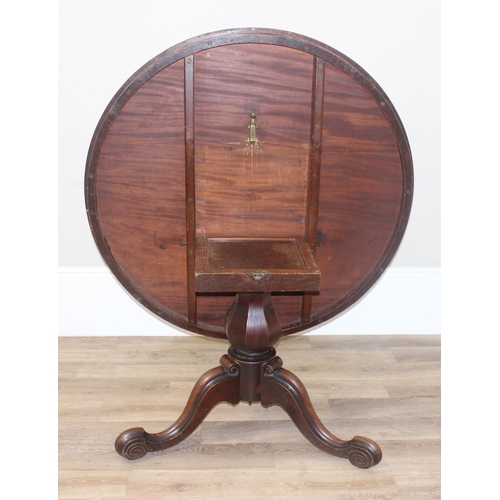 45 - A Victorian mahogany tilt topped breakfast table with pillar support and swirl carved feet, approx 1... 