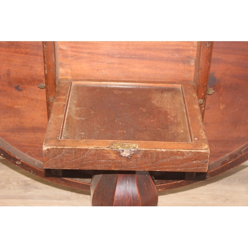 45 - A Victorian mahogany tilt topped breakfast table with pillar support and swirl carved feet, approx 1... 