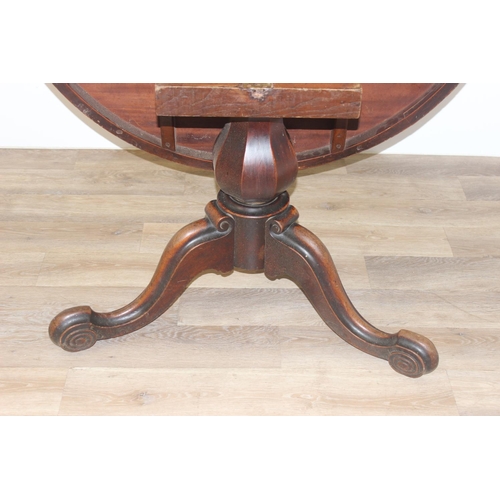 45 - A Victorian mahogany tilt topped breakfast table with pillar support and swirl carved feet, approx 1... 