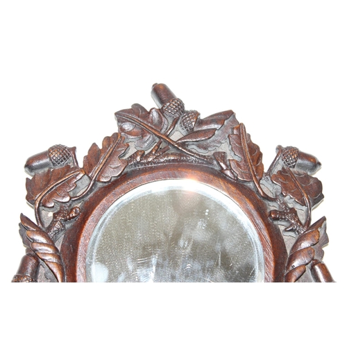 1486 - An antique Black Forest carved wooden hand mirror decorated with oak leaves and acorns, approx 35cm ... 