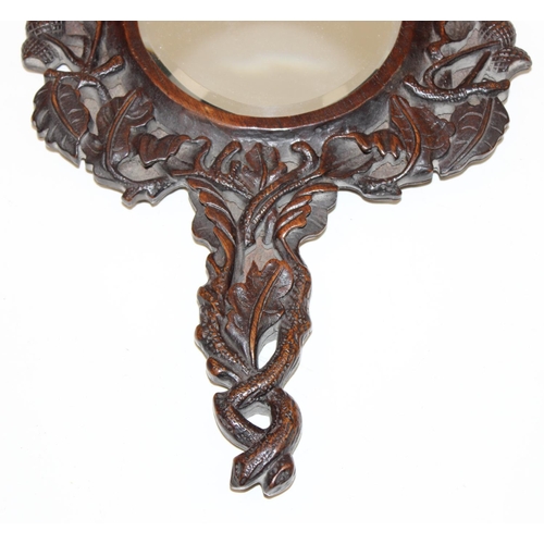 1486 - An antique Black Forest carved wooden hand mirror decorated with oak leaves and acorns, approx 35cm ... 