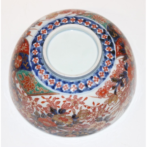 1487 - An antique Chinese or Japanese porcelain bowl with Imari colours, the centre decorated with a dragon... 