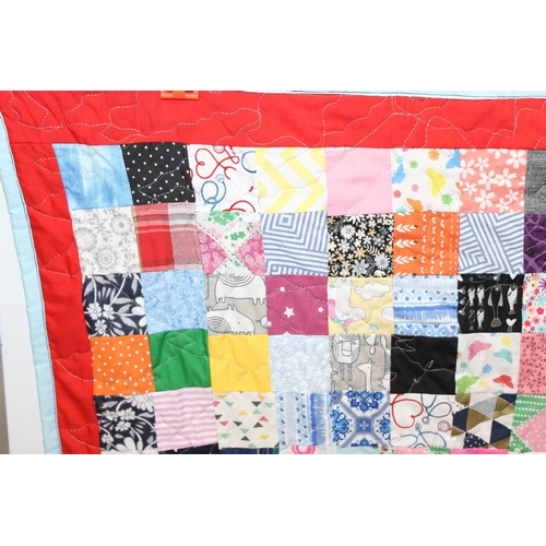 216 - A modern and highly colourful patchwork quilt with fleece backing, approx 144cm x 103cm