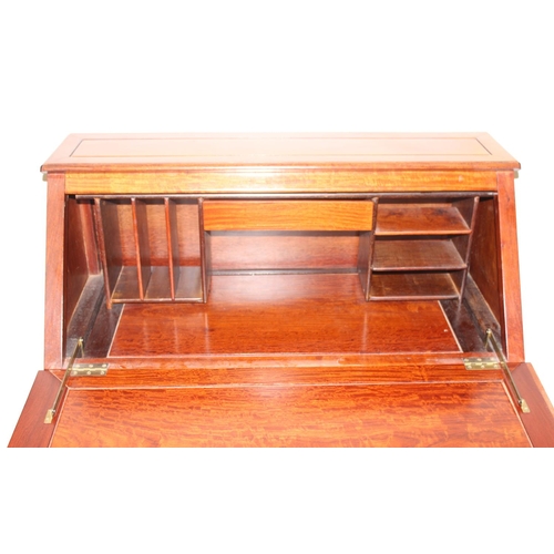 64 - A 20th century Chinese hardwood bureau with drop down front and 2 over 3 drawers to base, carved Chi... 