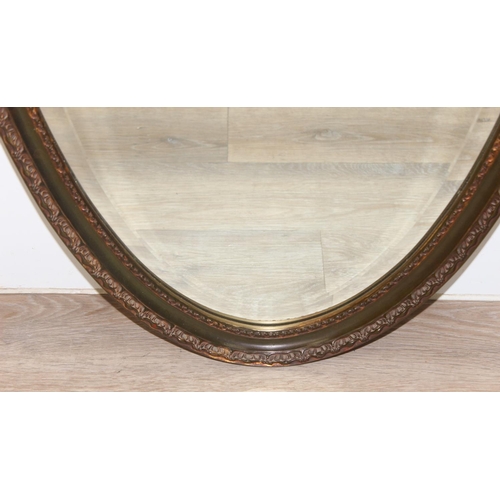 459A - An antique style distressed gilt framed oval shaped wall mirror, approx 98cm x 52cm