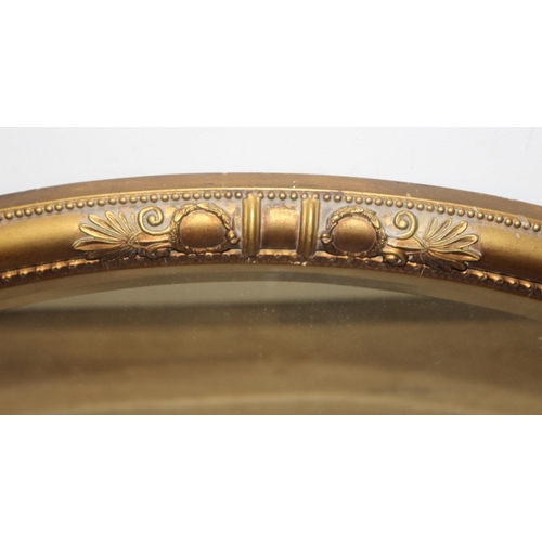 459B - An antique gilt framed oval shaped wall mirror, approx 83cm x 57cm