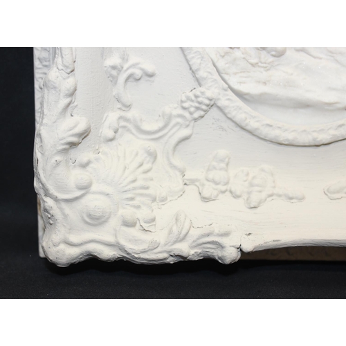 459F - An antique style reconstituted marble plaque in distressed white painted frame, the relief plaque de... 