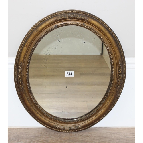 548 - Antique oval gilt framed mirror with rope twist border and floral decoration, approx 50cm W x 58cm H