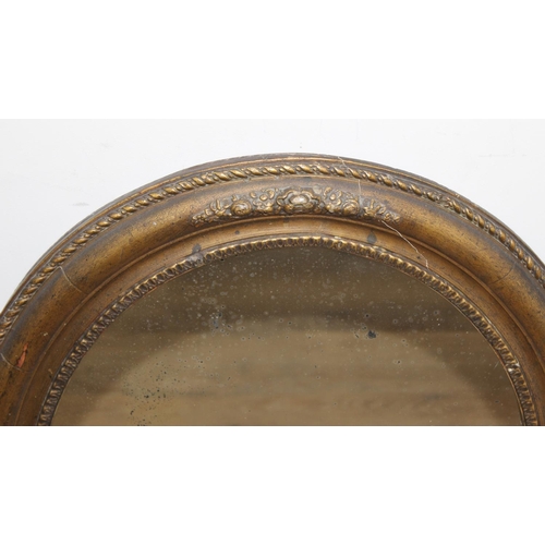 548 - Antique oval gilt framed mirror with rope twist border and floral decoration, approx 50cm W x 58cm H