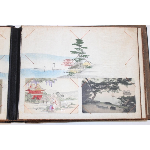 598 - An early 20th century Japanese black lacquer and Shibayama inlaid photograph album containing photog... 