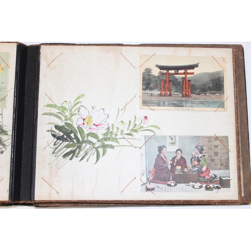 598 - An early 20th century Japanese black lacquer and Shibayama inlaid photograph album containing photog... 