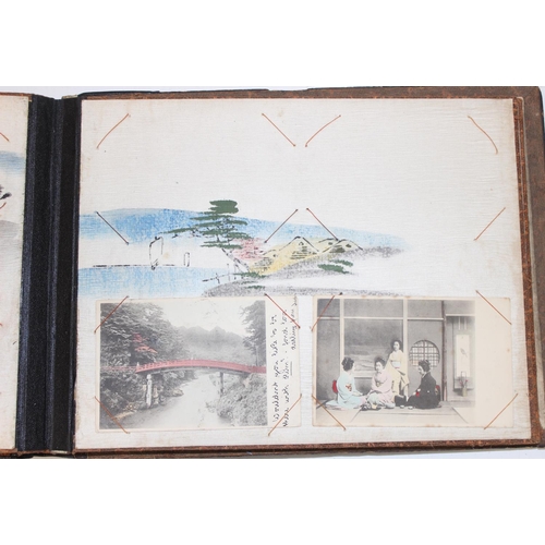 598 - An early 20th century Japanese black lacquer and Shibayama inlaid photograph album containing photog... 