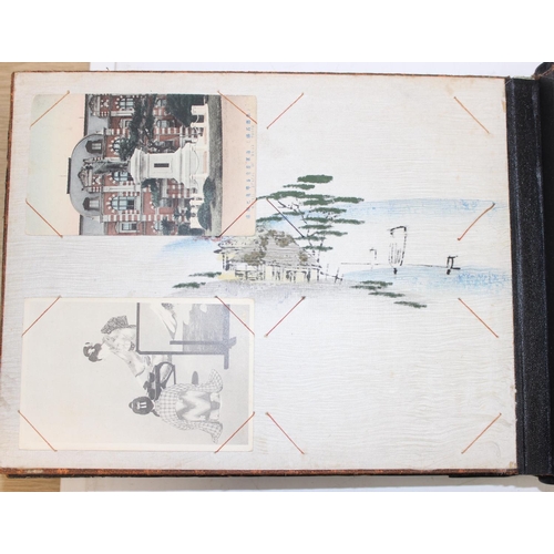 598 - An early 20th century Japanese black lacquer and Shibayama inlaid photograph album containing photog... 