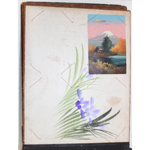 598 - An early 20th century Japanese black lacquer and Shibayama inlaid photograph album containing photog... 